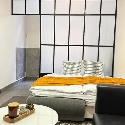 a bedroom with a bed and a table at The Rest Point Prague in Prague