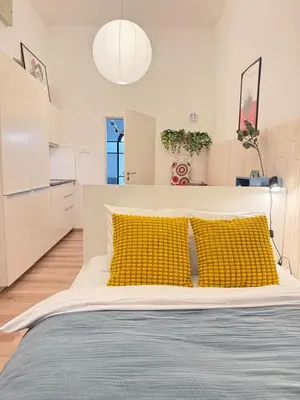 a bedroom with a large bed with yellow pillows at The Rest Point Prague in Prague