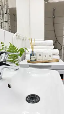 a bathroom with a white sink and towels at The Rest Point Prague in Prague