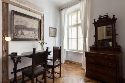 a room with a desk and a dresser and a window at Dlouhá Art & Antique Stay in Prague
