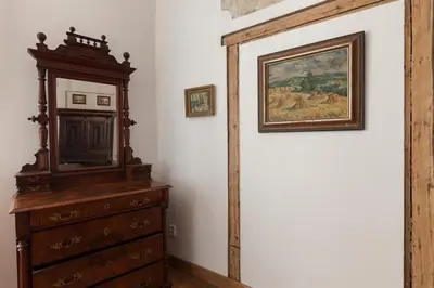 a room with a dresser and a painting on the wall at Dlouhá Art & Antique Stay in Prague