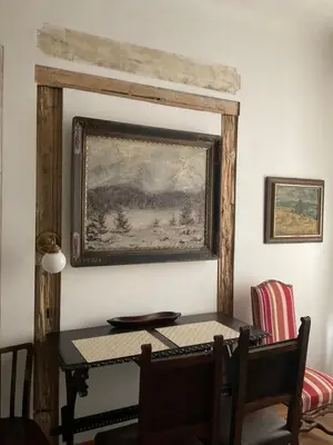 a dining room table with a painting on the wall at Dlouhá Art & Antique Stay in Prague