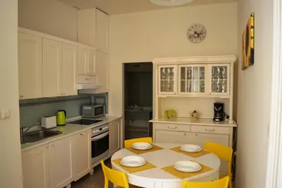 a kitchen with a table and yellow chairs in it at Sunflower 2BDR Flat By Ruterra in Prague