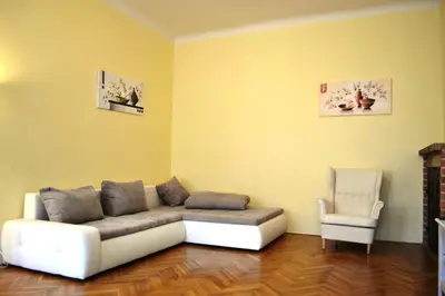 a living room with a couch and a chair at Sunflower 2BDR Flat By Ruterra in Prague