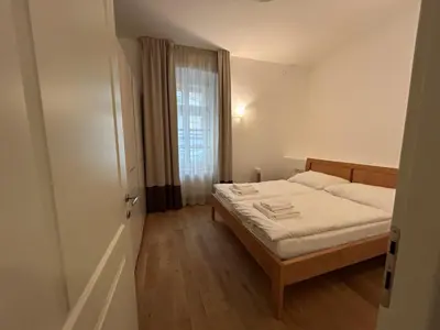 a small bedroom with a bed and a window at Vip Prague Apartments Petrska 25 in Prague