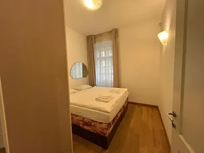 a small bedroom with a bed and a window at Vip Prague Apartments Petrska 25 in Prague