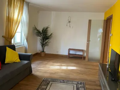 a living room with a couch and a tv at Vip Prague Apartments Petrska 25 in Prague
