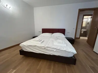a bedroom with a bed with white sheets and towels at Vip Prague Apartments Petrska 25 in Prague