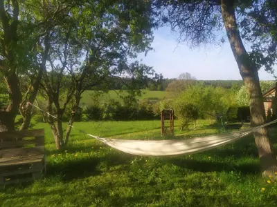 a hammock hanging between two trees in a field at Maringotka Waldeck in Ohrazenice