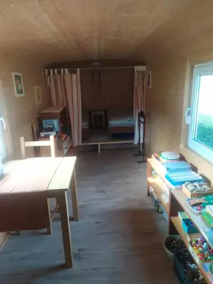 a room with a table and a room with a bed at Maringotka Waldeck in Ohrazenice