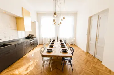 a large kitchen with a long table with chairs at Florentinum Residence Prague Old Town in Prague