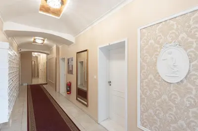 a hallway with a clock on a wall at Peter's Square Residence in Prague