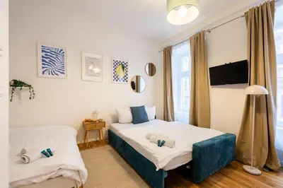 a small bedroom with a bed and a window at Peter's Square Residence in Prague