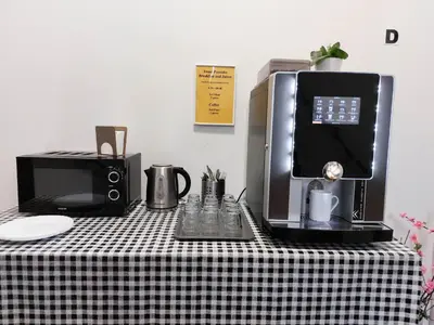 a black and white table with a coffee maker and a microwave at Ubytování blízko národního muzea A1 in Prague