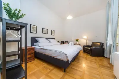 a bedroom with a bed and a chair at Nerudova Lesser Town Apartments in Prague