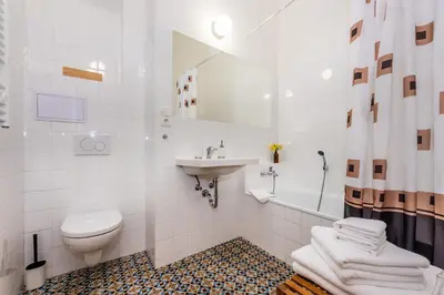 a white bathroom with a sink and a toilet at Nerudova Lesser Town Apartments in Prague