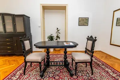 a dining room with a table and two chairs at Nerudova Lesser Town Apartments in Prague
