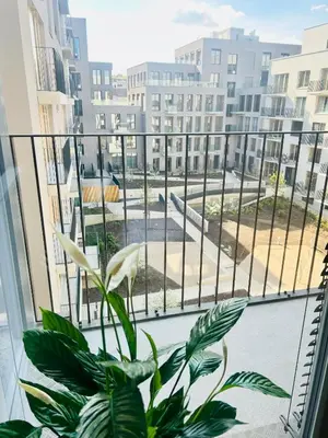 a balcony with a large window with a plant at New building New apartment at Andel Metro Station in Prague