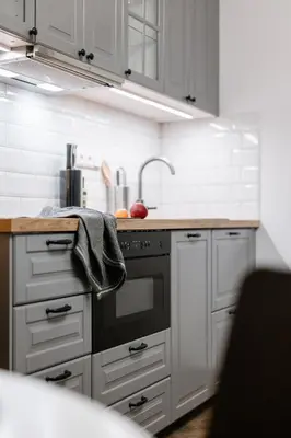 a kitchen with white cabinets and a stove top oven at Meloun City Center Residence in Prague
