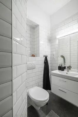 a white bathroom with a toilet and a sink at Meloun City Center Residence in Prague