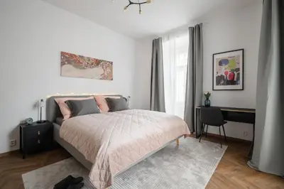 a bedroom with a bed and a desk in it at Meloun City Center Residence in Prague