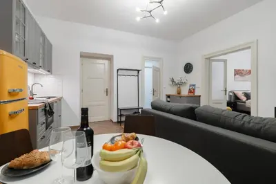 a living room with a table with a plate of fruit at Meloun City Center Residence in Prague