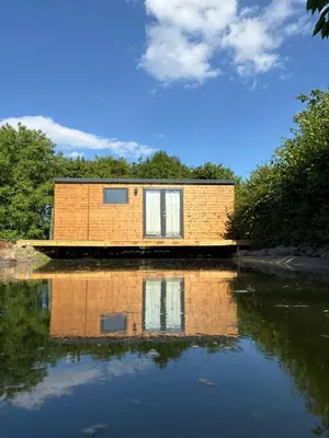 a house sitting on top of a body of water at Sádky Lety in Lety