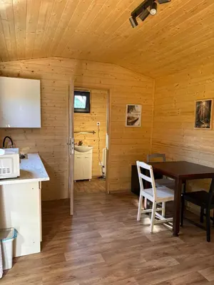a kitchen and dining room with a table and chairs at Sádky Lety in Lety