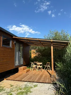 a wooden deck with a table and chairs on it at Sádky Lety in Lety