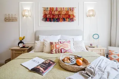 a bedroom with a bed with a basket of food on it at Prague Days - Boho One-bedroom Apartment with Netflix in Vinohrady in Prague
