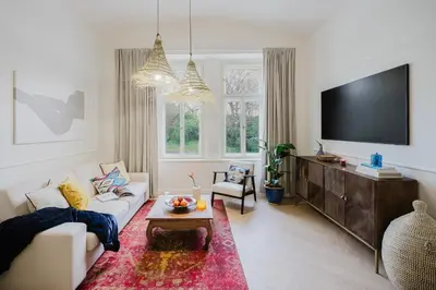 a living room with a couch and a tv at Prague Days - Boho One-bedroom Apartment with Netflix in Vinohrady in Prague