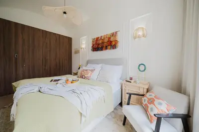 a small bedroom with a bed and a chair at Prague Days - Boho One-bedroom Apartment with Netflix in Vinohrady in Prague