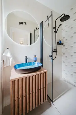 a bathroom with a blue sink and a shower at Prague Days - Boho One-bedroom Apartment with Netflix in Vinohrady in Prague