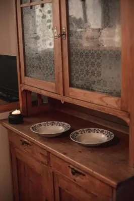 a wooden cabinet with two plates on top of it at Statek Adámek in Borotice