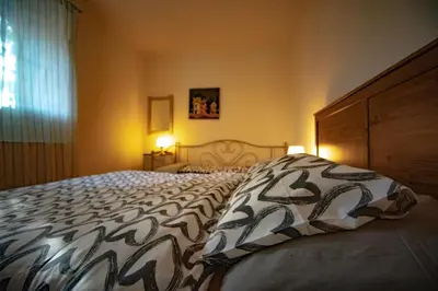 a bedroom with a large bed with a pillow on it at Statek Adámek in Borotice