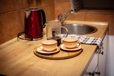 a counter with two cups and a glass on it at Statek Adámek in Borotice