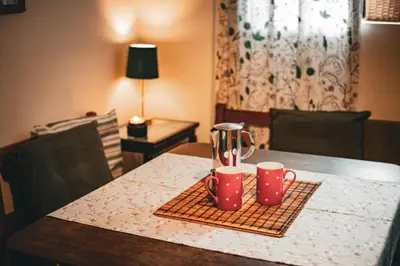 a table with two coffee mugs on top of it at Statek Adámek in Borotice