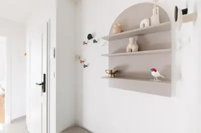 a room with white walls and white shelves at Modern Flat in Iconic Location in Prague