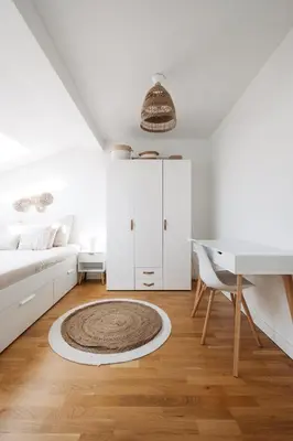 a white living room with a couch and a desk at Modern Flat in Iconic Location in Prague