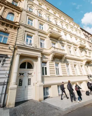 a group of people walking in front of a building at Modern Flat in Iconic Location in Prague