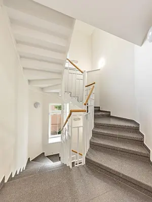 a staircase in a house with white walls at Cosy Studio in Vysehrad in Prague