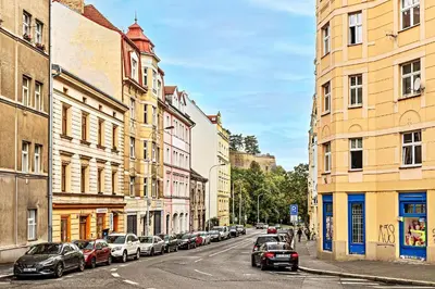 a city street with cars parked on the street at Cosy Studio in Vysehrad in Prague