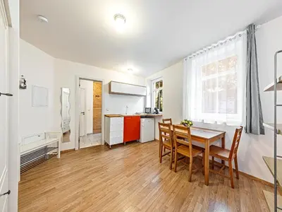 a kitchen and dining room with a table and chairs at Cosy Studio in Vysehrad in Prague