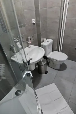 a bathroom with a sink and a toilet at Penzion a restaurace U Jágrů in Kladno
