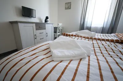 a bedroom with two beds with white towels on them at Penzion a restaurace U Jágrů in Kladno