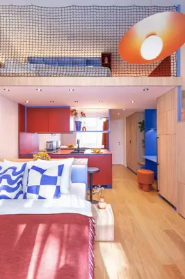 a bedroom with a large bed and a kitchen at TurnKey I Vinohrady Modern Apartments in Prague