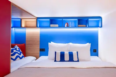 a bedroom with a bed with blue and red at TurnKey I Vinohrady Modern Apartments in Prague