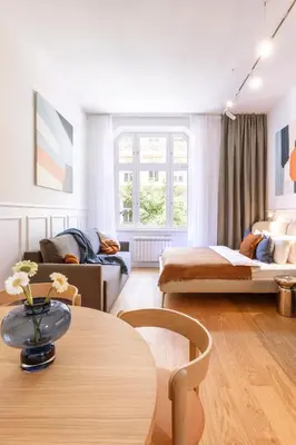 a living room with a couch and a table at TurnKey I Vinohrady Modern Apartments in Prague