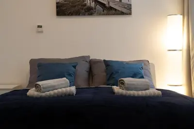 a bed with two pillows on top of it at Blue Courtyard Retreat Quiet Green View in Prague