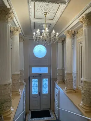 a large room with a door and a chandelier at Blue Courtyard Retreat Quiet Green View in Prague